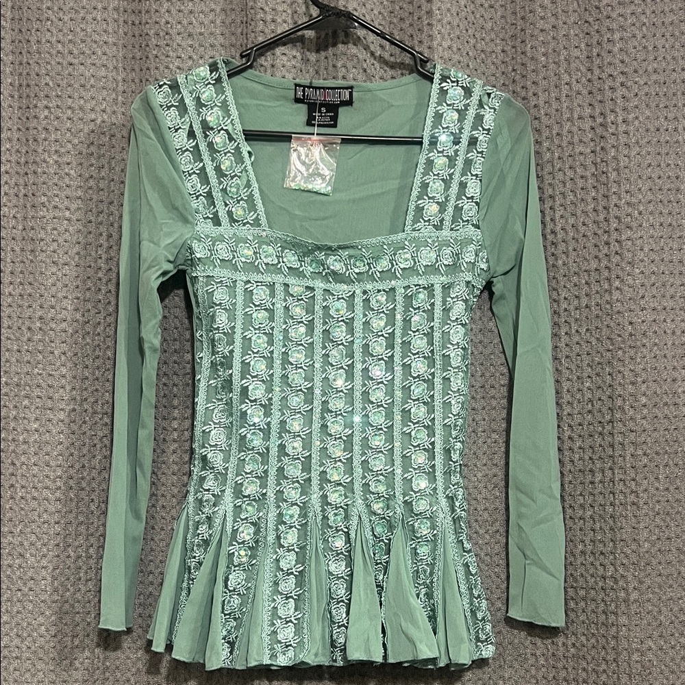 Gorgeous Long Sleeve Top with accents. Perfect for a night out.